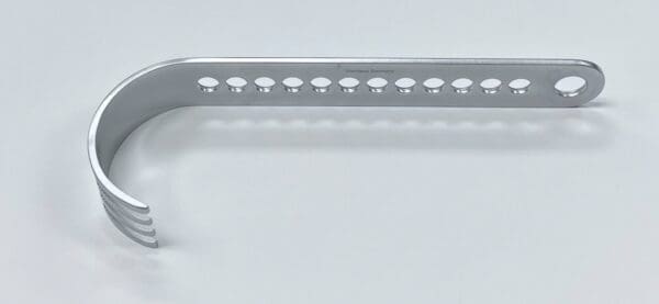 A CHARNLEY INITIAL INCISION BLADE holder with holes on a white surface.