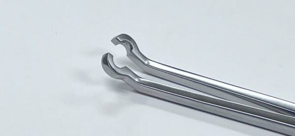 A pair of Acetabular Screw Holding Forceps on a white surface.