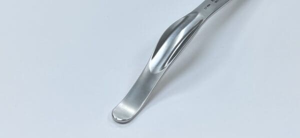 A Humeral Head Retractor on a white surface.