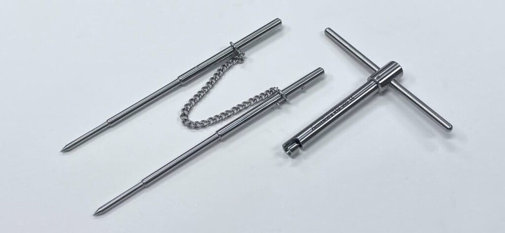 A CHARNLEY PIN RETRACTOR SET with a chain attached to them.