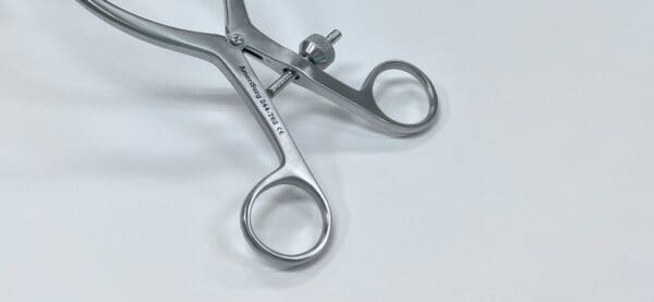 A ZELPI STYLE WEITLANER RETRACTOR on a white surface.