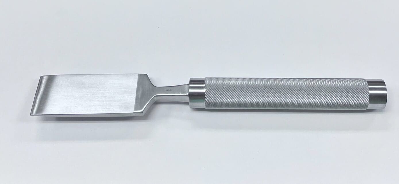 A COBB OSTEOTOME on a white surface.