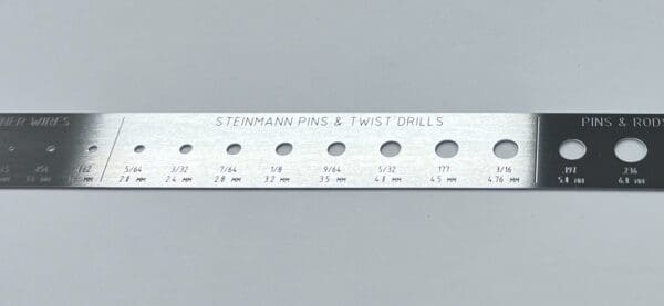 A RULER, K-WIRE AND PIN GAUGE with holes and numbers.
