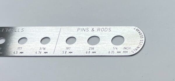 A piece of metal with a RULER, K-WIRE AND PIN GAUGE on it.
