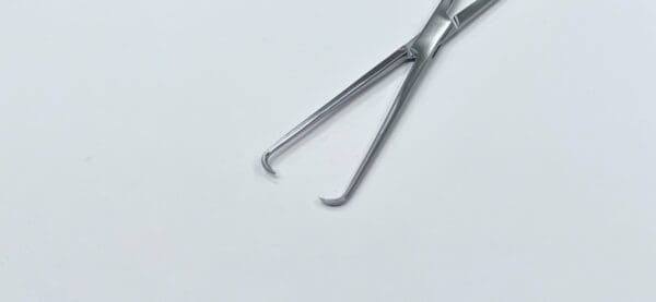 A pair of BRAUN TENACULUM FORCEP on a white surface.