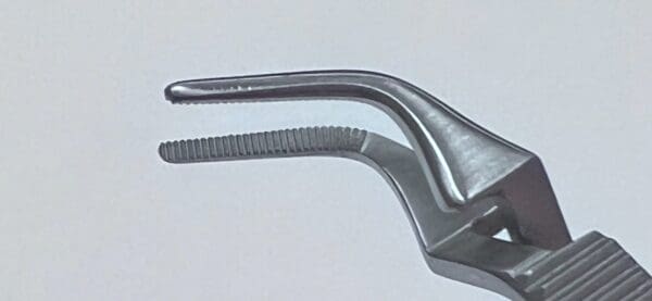 A silver DIETHRICH MICRO-CORONARY BULLDOG CLAMP with a curved handle.