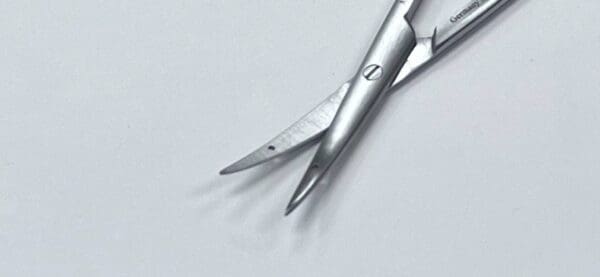 A LITTLER SUTURE CARRYING SCISSOR on a white surface.