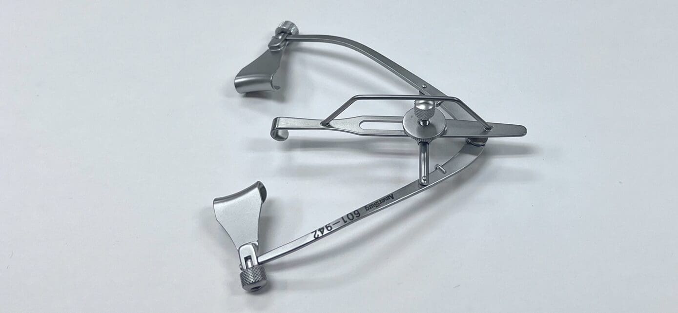 A MAUMENEE-PARK SPECULUM, SOLID crossbow on a white surface.