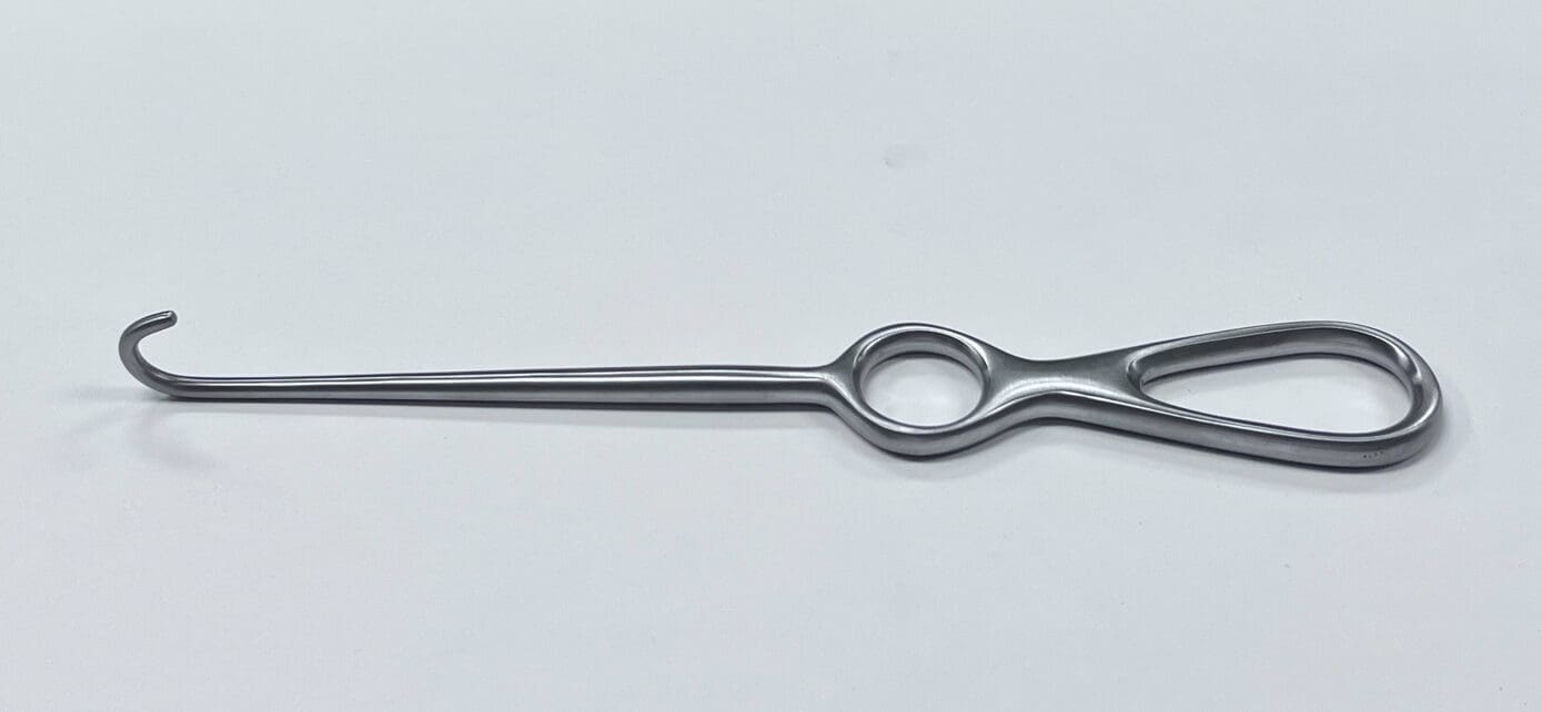 A VOLKMAN BONE HOOK with a handle on a white surface.