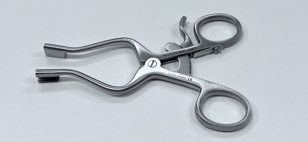A Burgess Type Carpal Tunnel Retractor on a white surface.