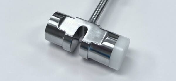 A stainless steel handle on a white surface. (slotted mallet)