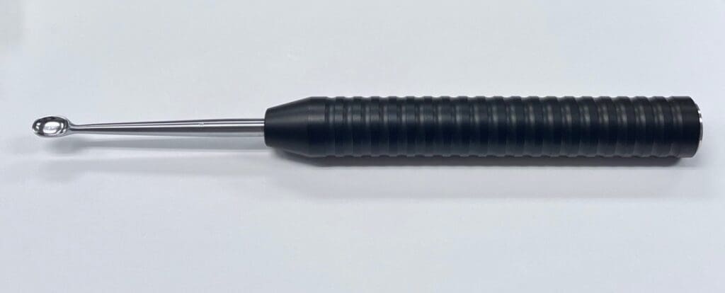 Magnum Curette Placed on a White Background
