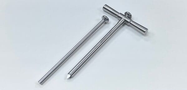 A pair of BONE BIOPSY KIT, 10MM tweezers on a white surface.