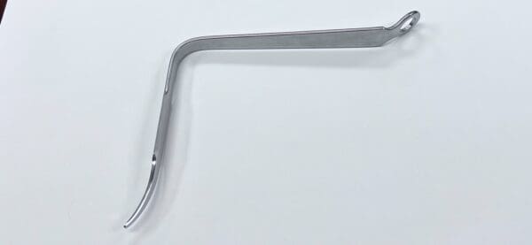 A Hohmann retractor, bent, narrow handle on a white surface.