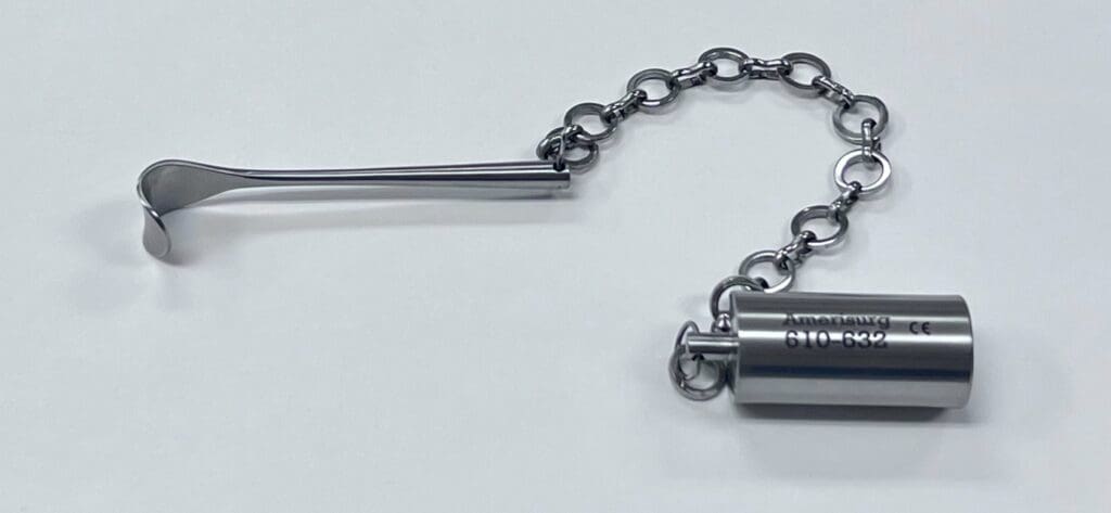 A DESMARRES WEIGHTED NASAL RETRACTOR with a chain attached to it.