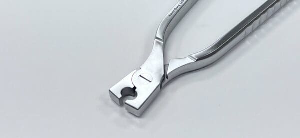 A pair of COMPACTION pliers on a white surface.