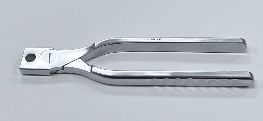 A COMPACTION PLIERS on a white surface.