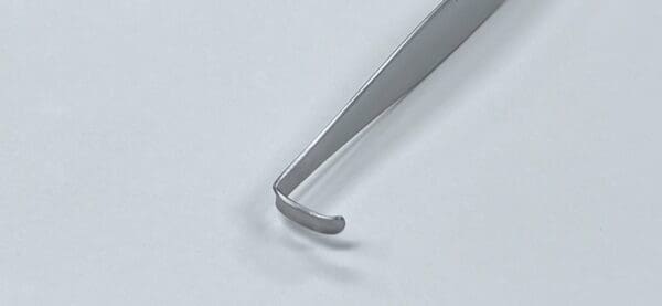 A CRILE RETRACTOR on a white surface.