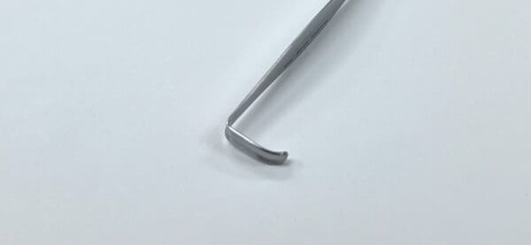 A CRILE RETRACTOR is sitting on top of a white surface.
