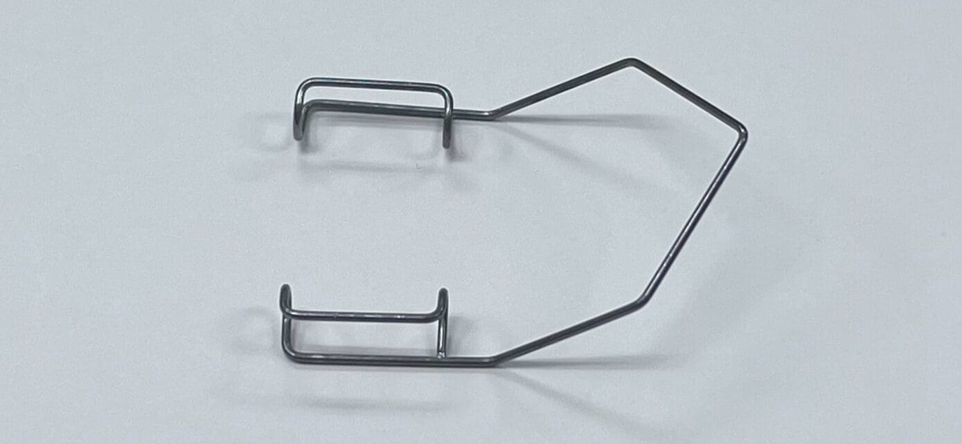 A pair of BARRAQUER EYE SPECULUM on a white surface.